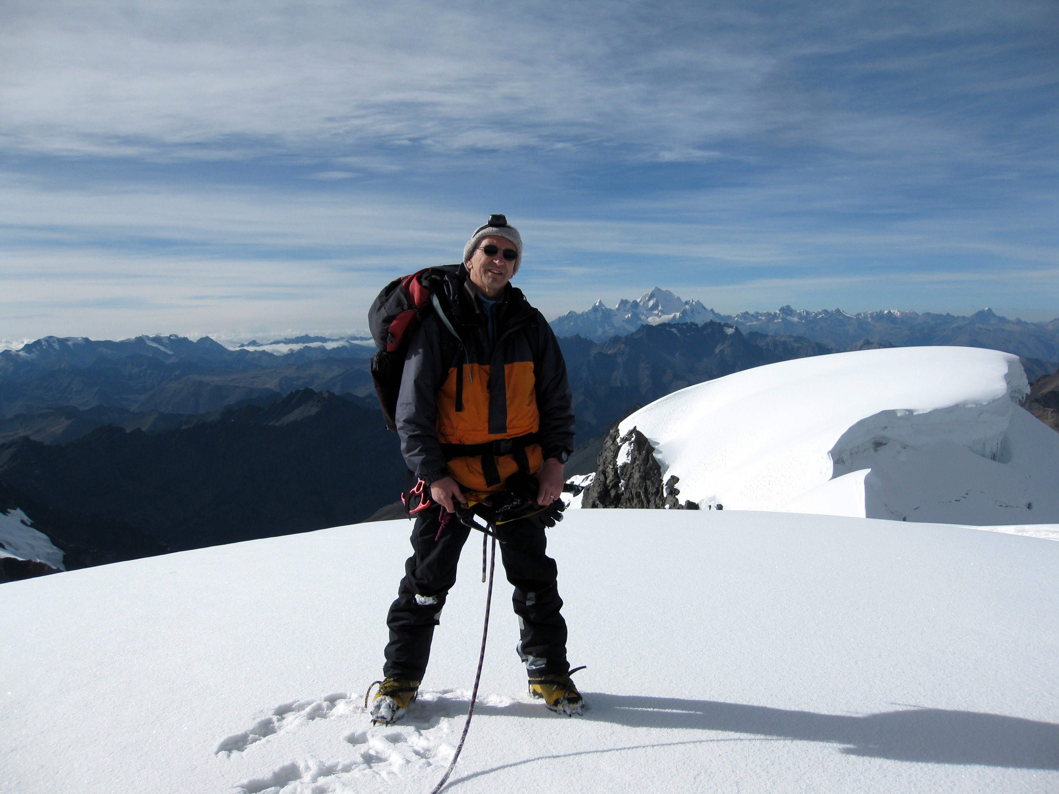 Bezanilla, an avid climber, poses at the summit of a mountain in the Andes